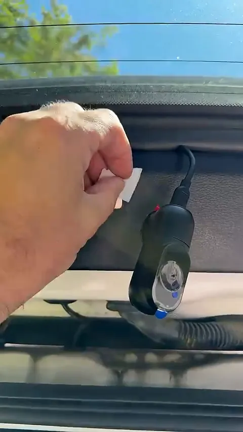 Rear camera mounted on metal clip inside Ford Expedition rear hatch