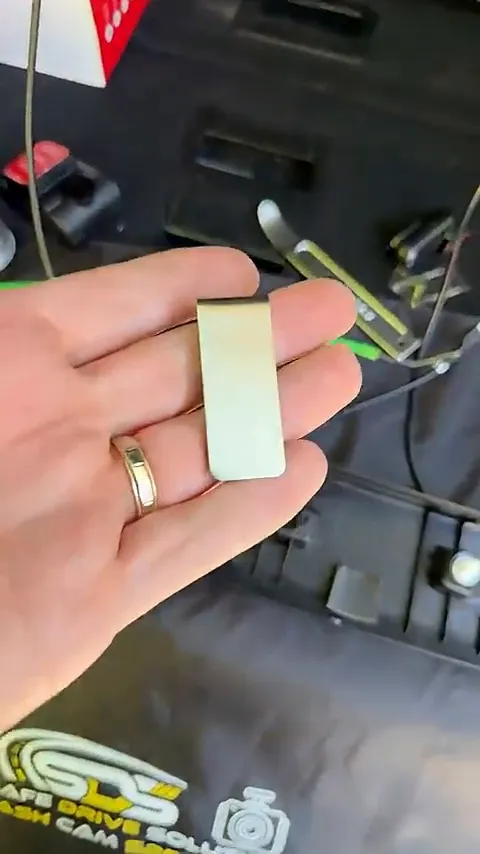 Money clip attached to metal panel inside Ford Expedition rear hatch