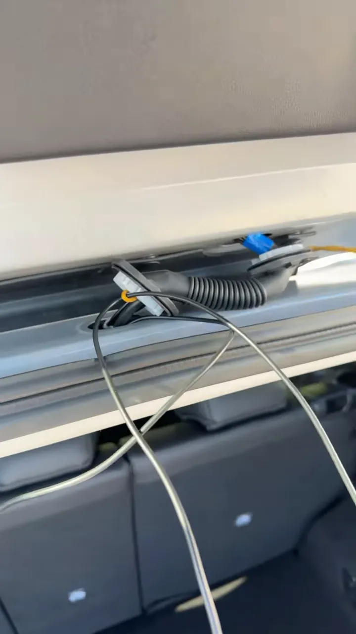 Close-up of dash cam wire routing along 2026 Mazda CX-5 A-pillar with tie straps and factory harness