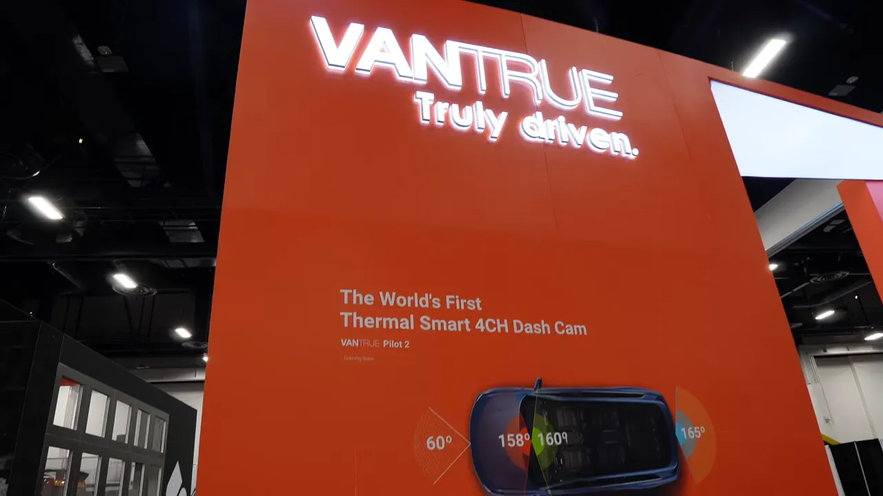Vantrue orange booth wall with text 'The World's First Thermal Smart 4CH Dash Cam' and a vehicle graphic
