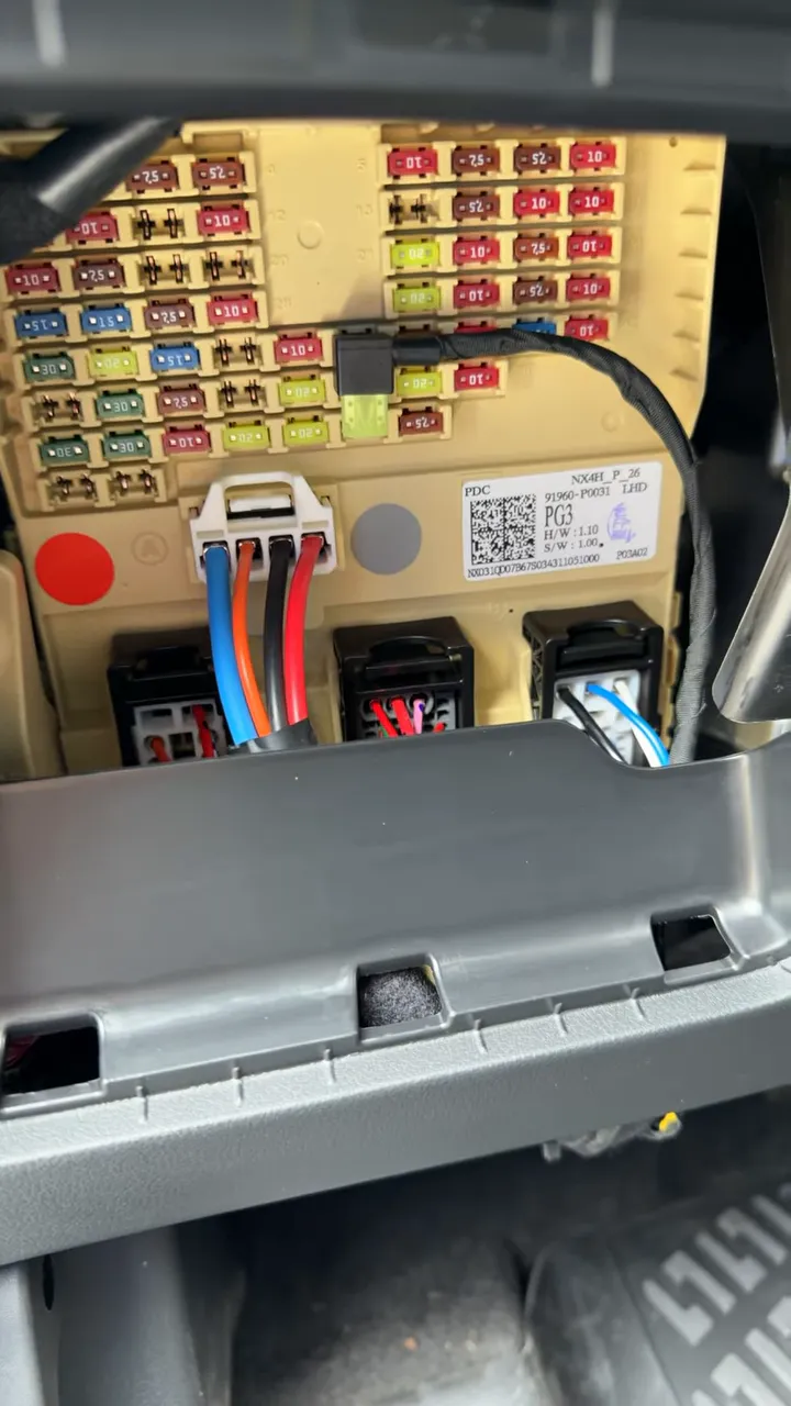 Clear view of Hyundai Tucson interior fuse box with dash cam battery pack power wiring connected