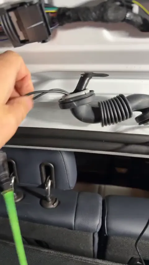 Pulling rear camera wire through hatch using looped tool