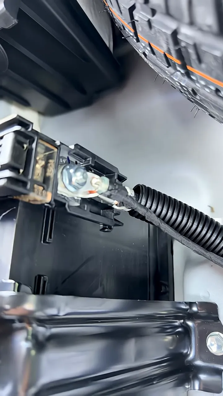 Dash cam battery pack wiring routed and secured in Lexus RX350h hatch battery compartment