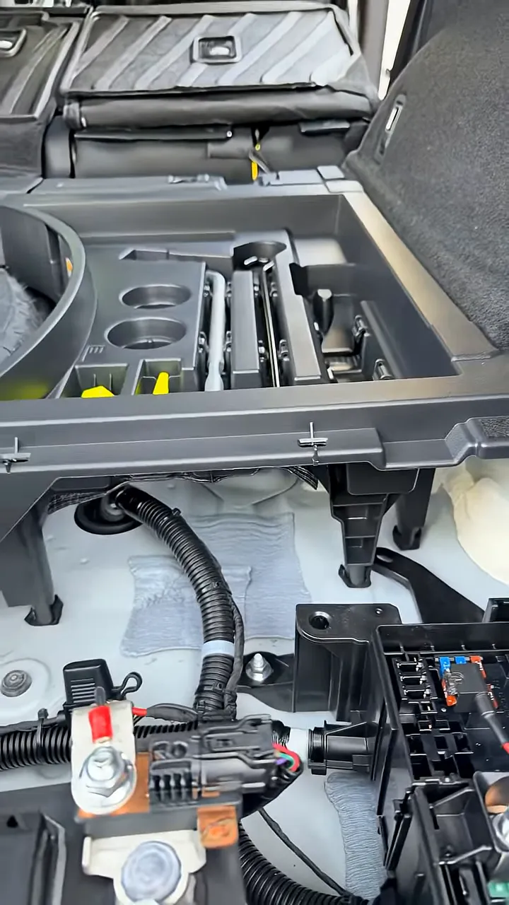 2026 Lexus RX350h rear hatch area with dash cam battery pack positioned under the paneling