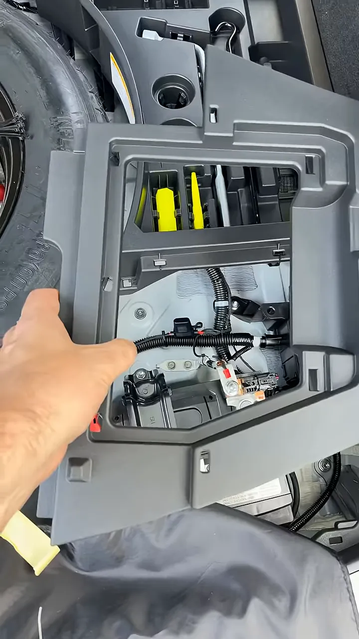 Lexus RX350h hatch area with dash cam power wiring visible before installing the relay and fuse box cover