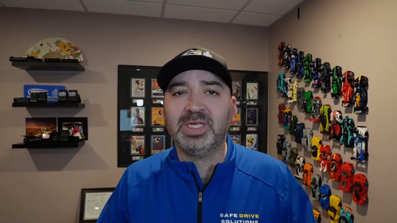 Presenter centered in office summarizing dash cam impact detection and rain performance