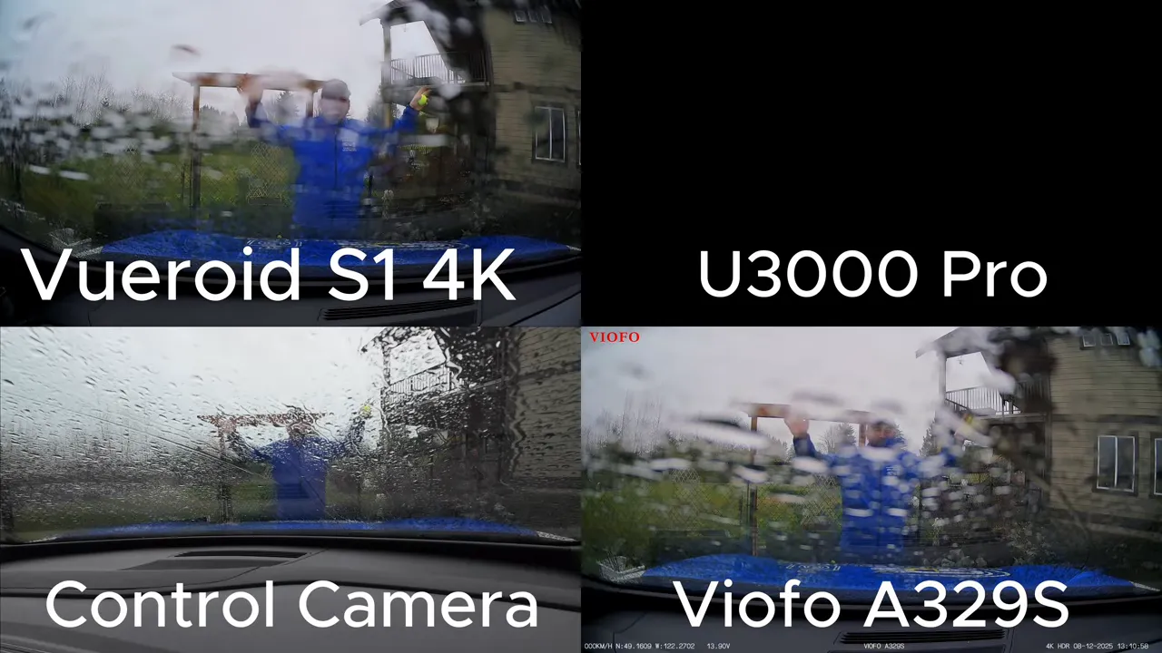 Split-screen comparison from three dashcams plus control camera during a driver-side fender impact in heavy rain; the tester is visible through the wet windshield in multiple camera frames.
