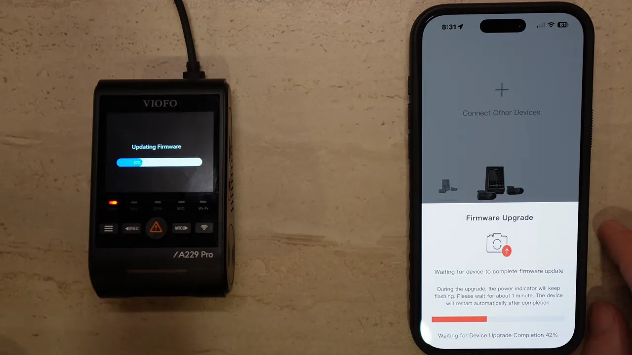 VIOFO A229 Pro dashcam screen showing updating firmware progress bar next to smartphone displaying firmware upgrade in app