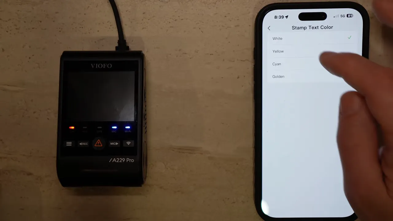 VIOFO app showing Stamp Text Color options list with White, Yellow, Cyan, Golden on the phone screen next to the dashcam