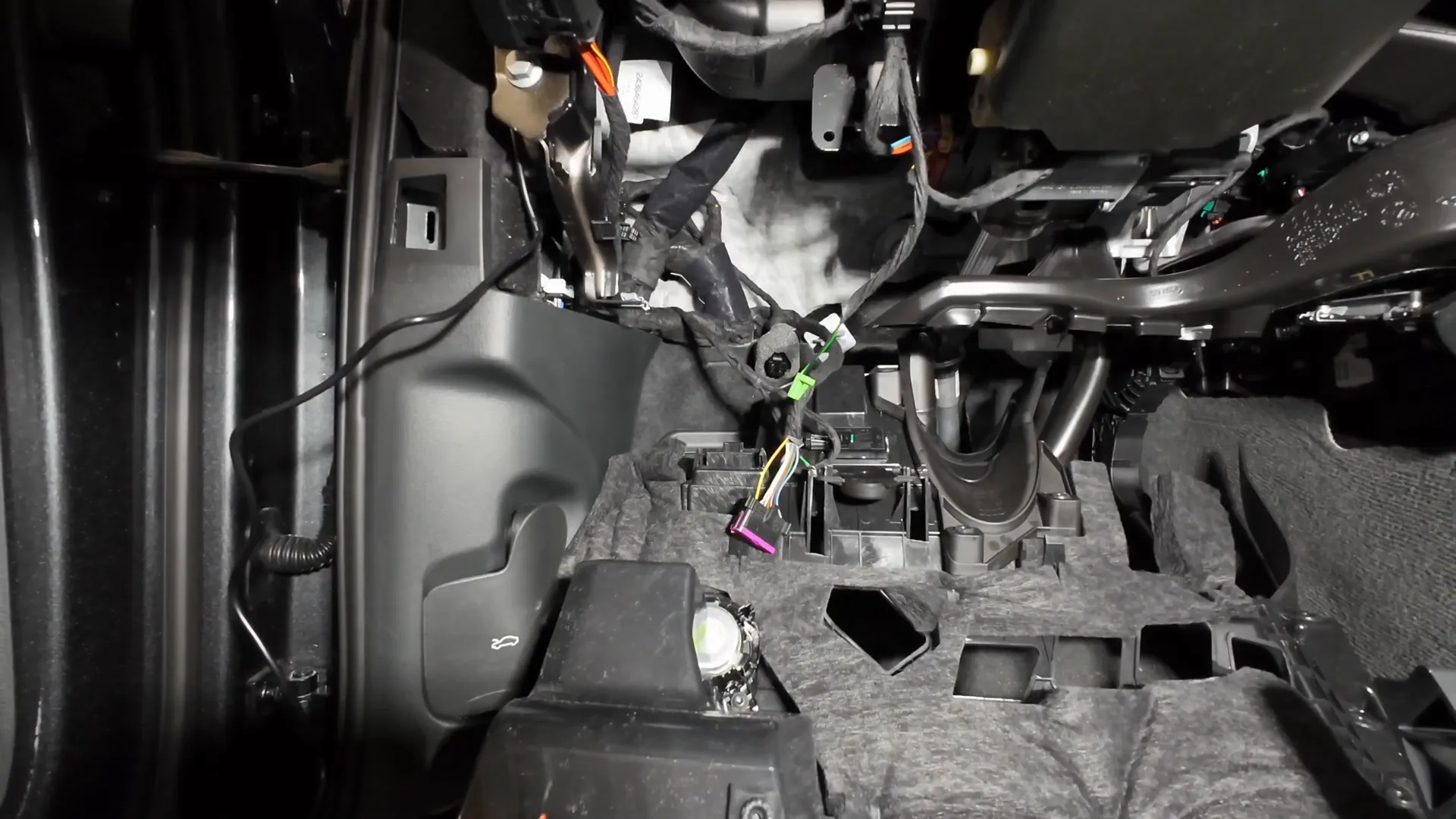 Accessing the OBD2 connector for power connections.