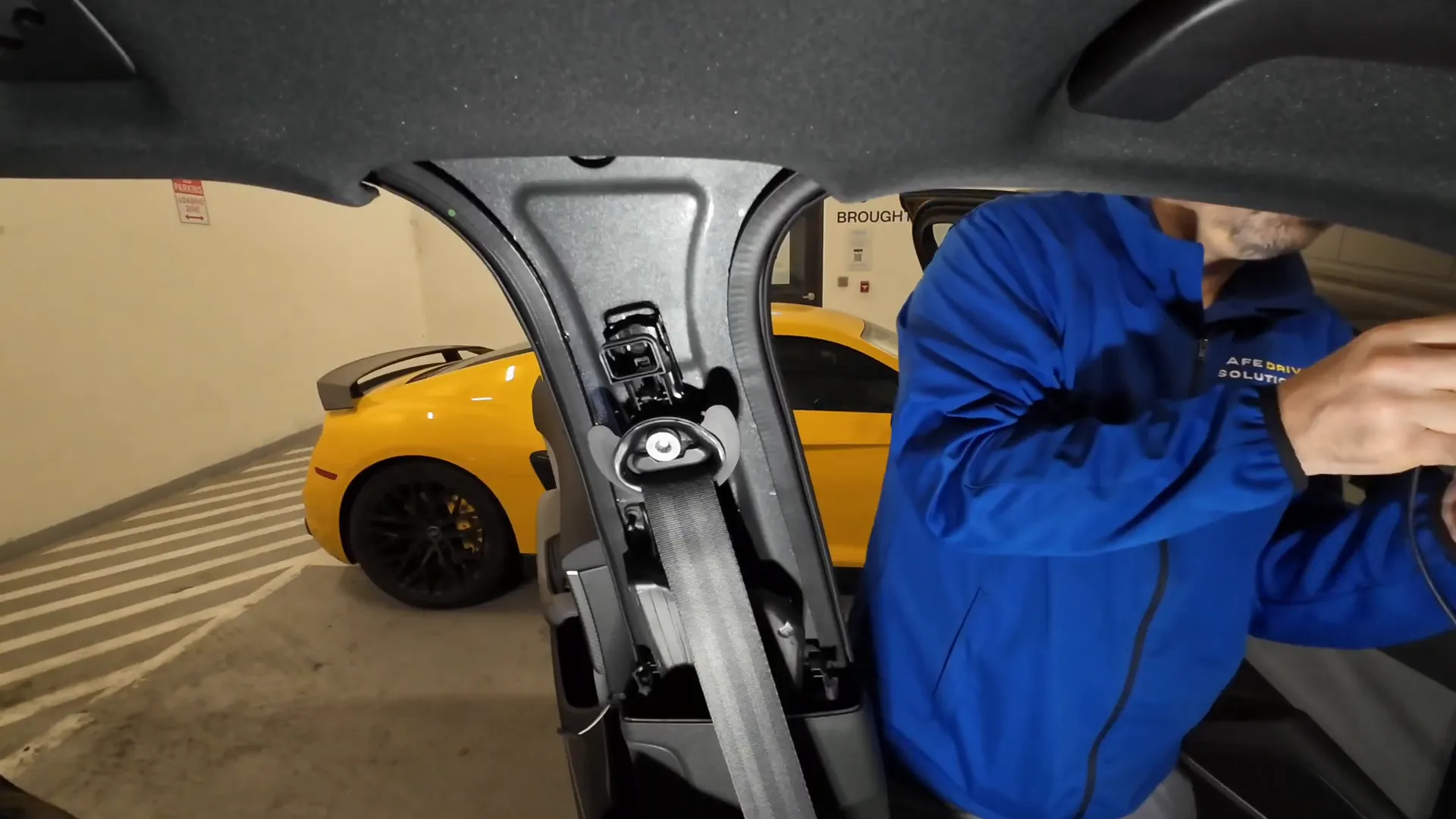 Running the rear camera cable through the B-pillar.