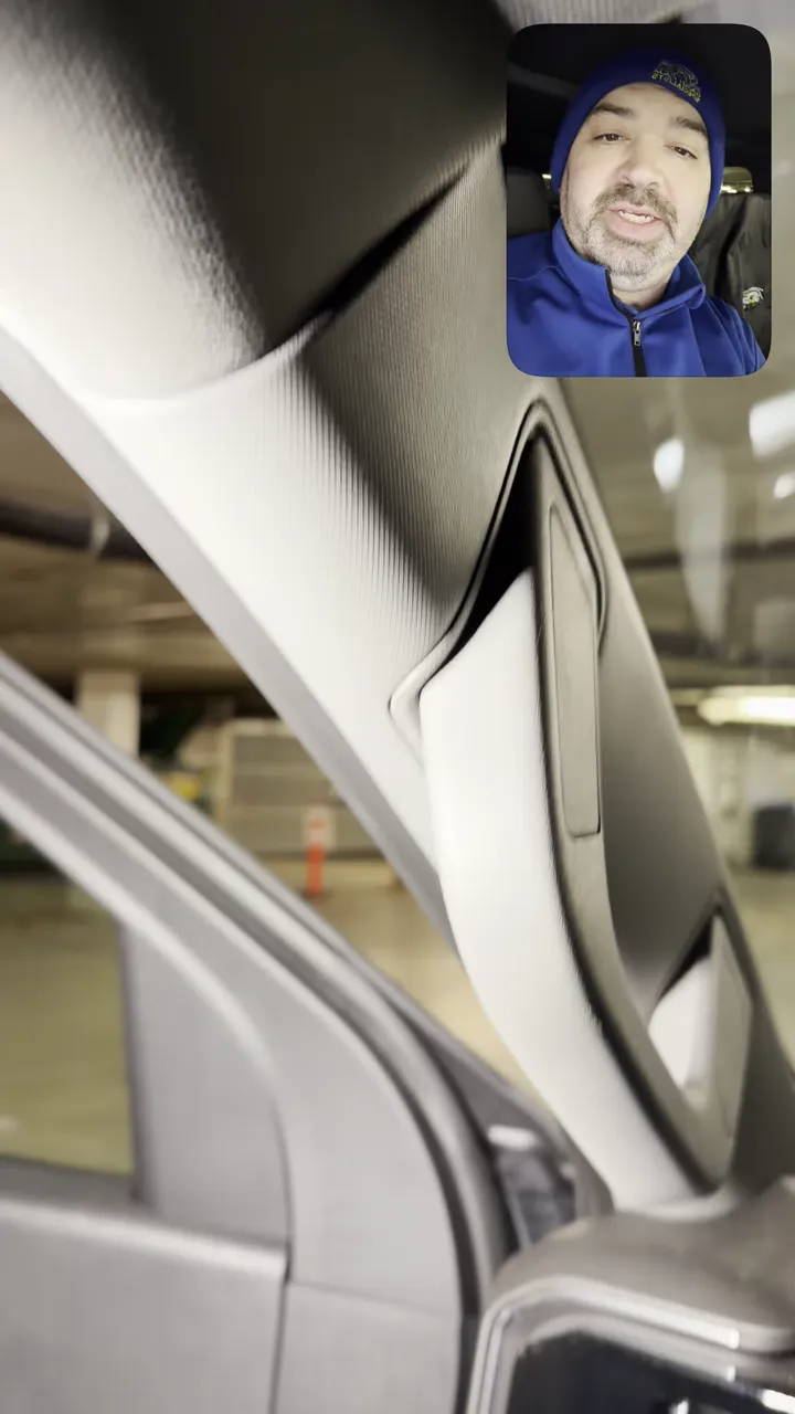 Detailed view of A‑pillar trim and headliner junction for hiding dash cam wiring