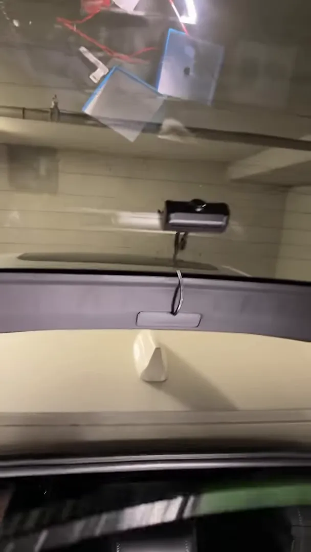 rear dashcam and cable hanging from hatch trim in Honda Civic