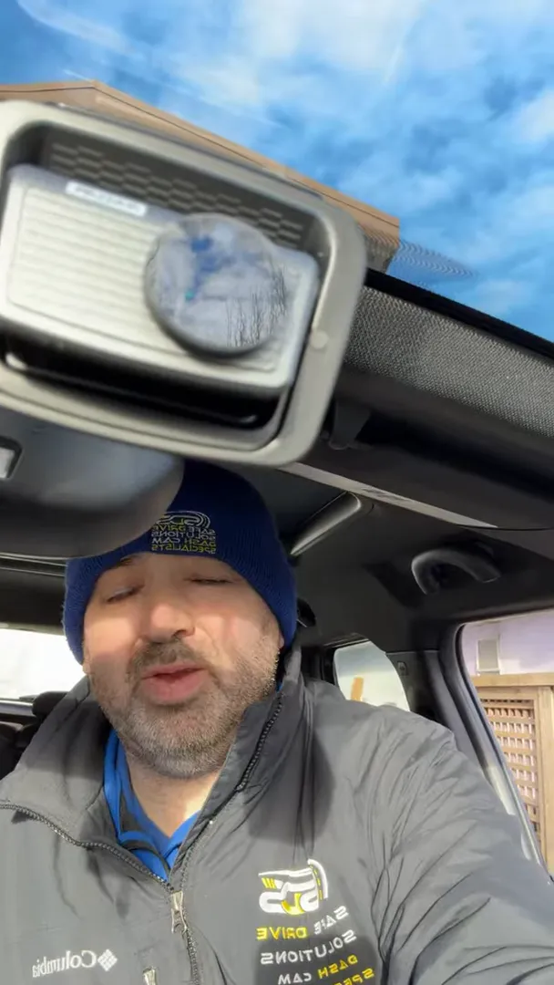 Thinkware-style dash cam mounted on Mini Cooper Countryman windshield showing final installation