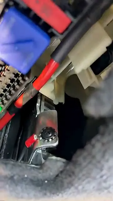 Close-up of metal bracket used for grounding behind the panel