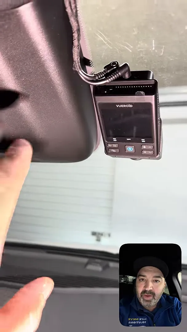 Clear close-up of a Vueroid front dash camera mounted just below the Equinox roof housing with wiring routed into the headliner