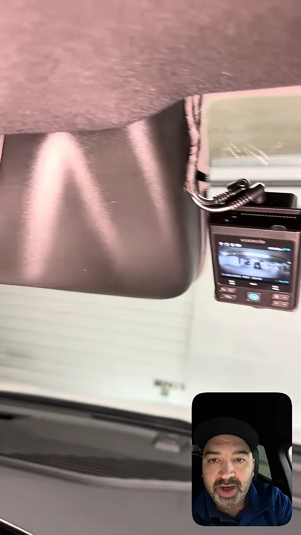 Dash camera mounted behind mirror with wiring routed into headliner on Chevrolet Equinox EV