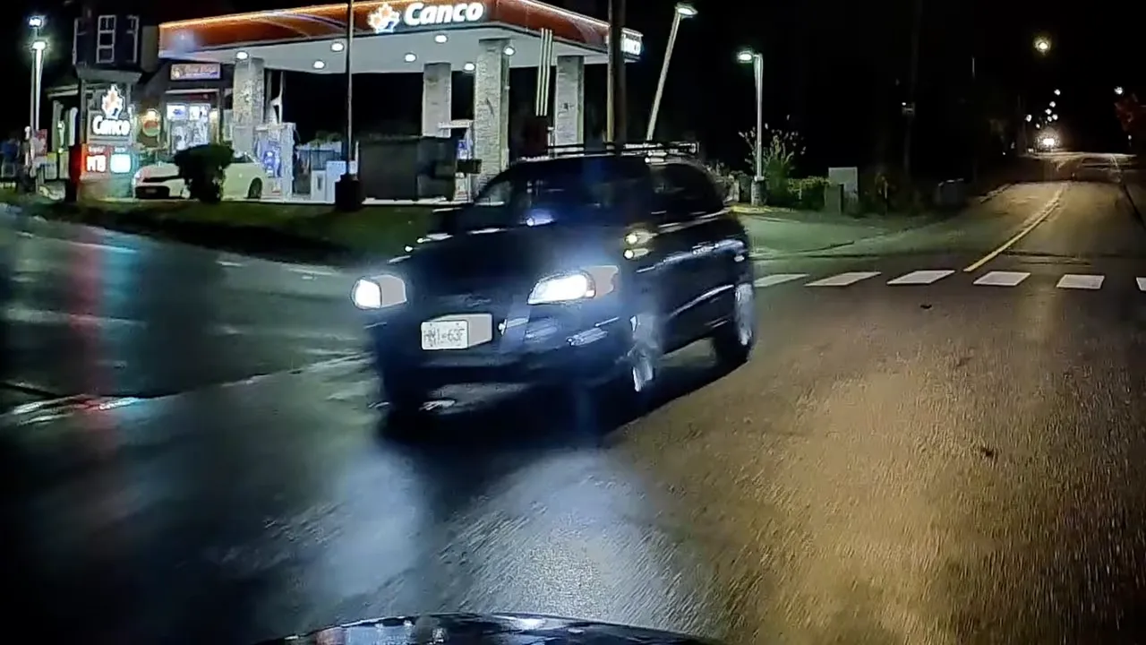 Night dash cam view of a parked vehicle at a gas station with a potentially readable license plate