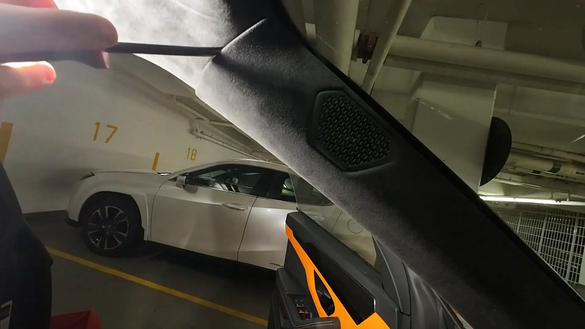 Using a hook to release the hidden clip on the A-pillar