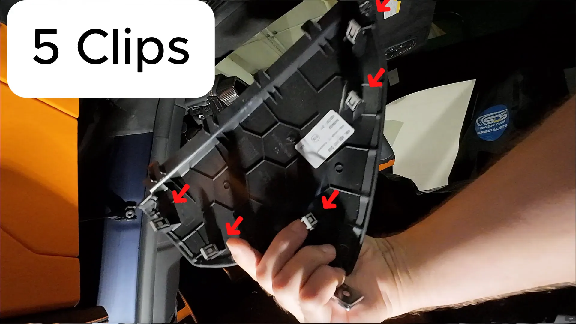 Backside of dash side panel showing the four clips to release