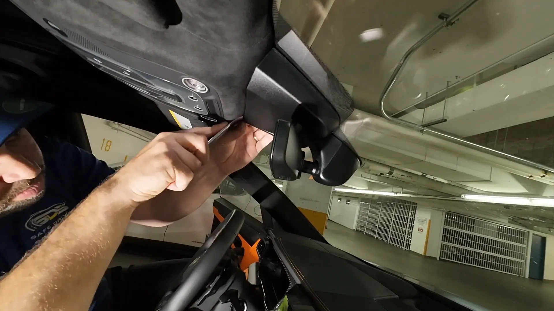 Removing the housing behind the rearview mirror with a rigid trim tool