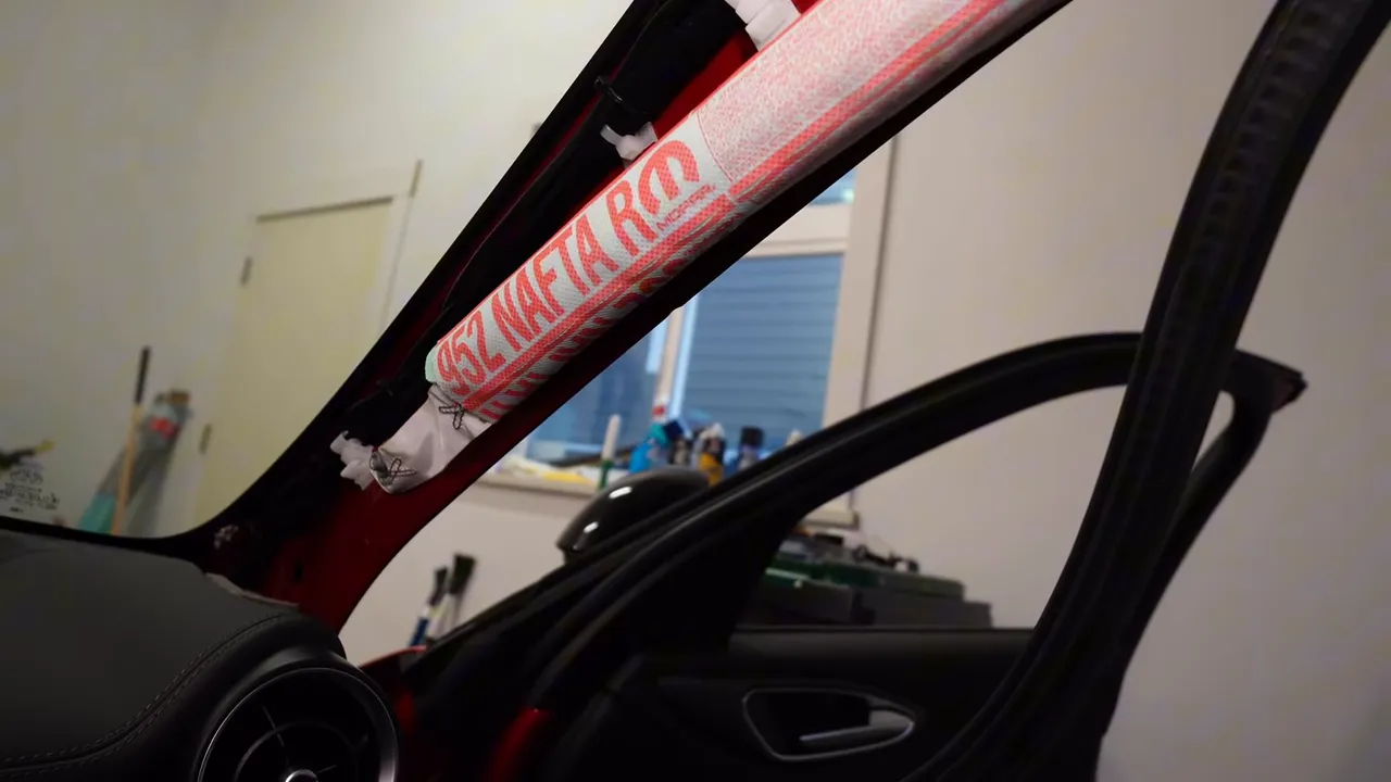 A-pillar trim removed with side airbag exposed, showing the space used to tuck the dash cam wiring behind the factory harness.