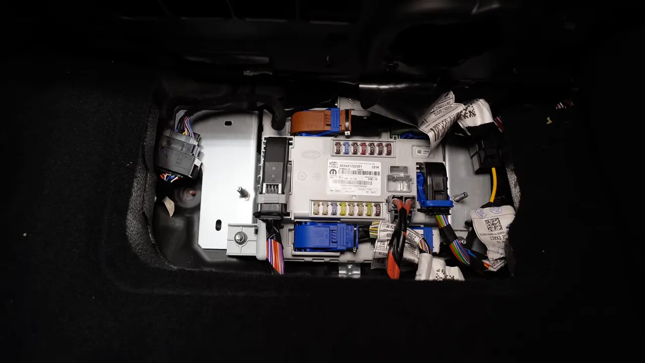 Alfa Romeo Giulia fuse panel behind side trim showing fuses and connectors