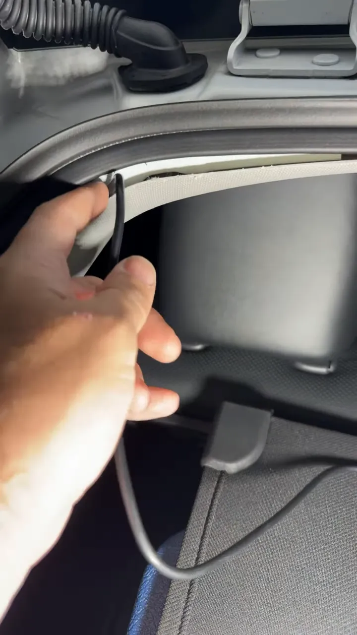 Rear camera cable tucked beneath lifted hatch weatherstripping