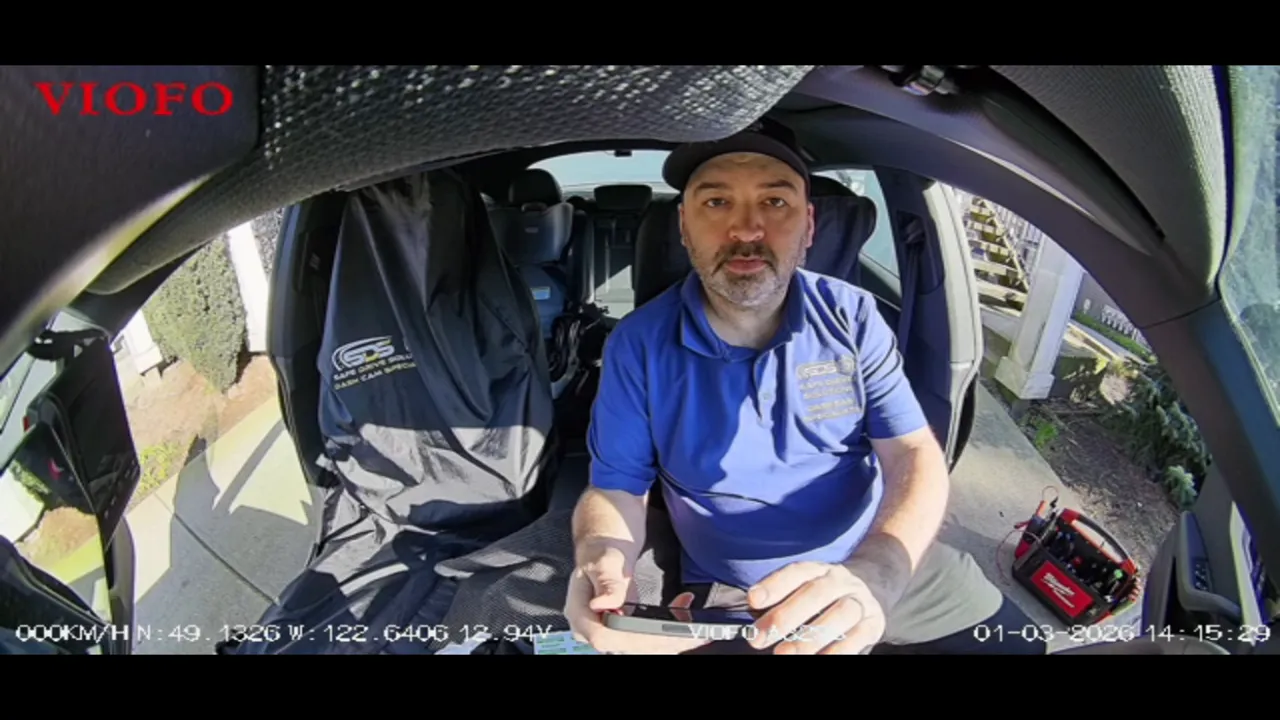 Installer seated in an Audi A5 with dash, wiring area and tool bag visible ready for final checks