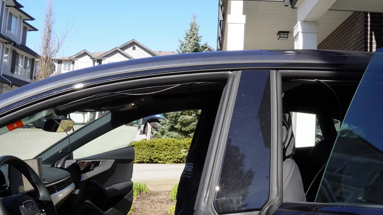 Dashcam cable routed along the window side of an Audi A5 A‑pillar and headliner