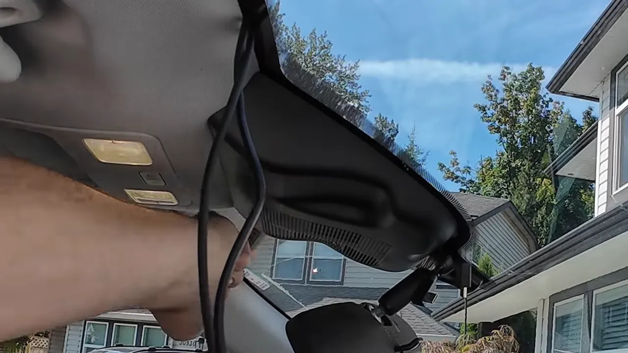 Cable routed through the rearview mirror housing and tucked into the headliner