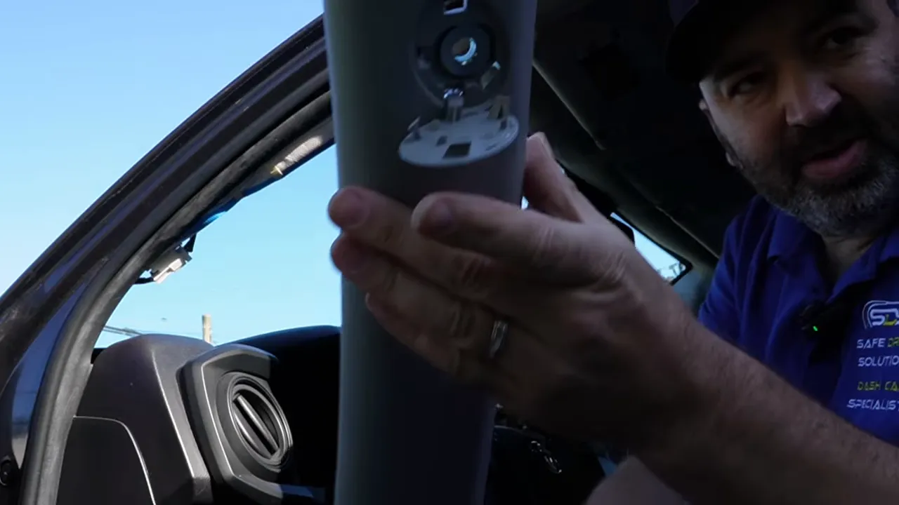 A pillar trim panel held up with SRS airbag cover visible
