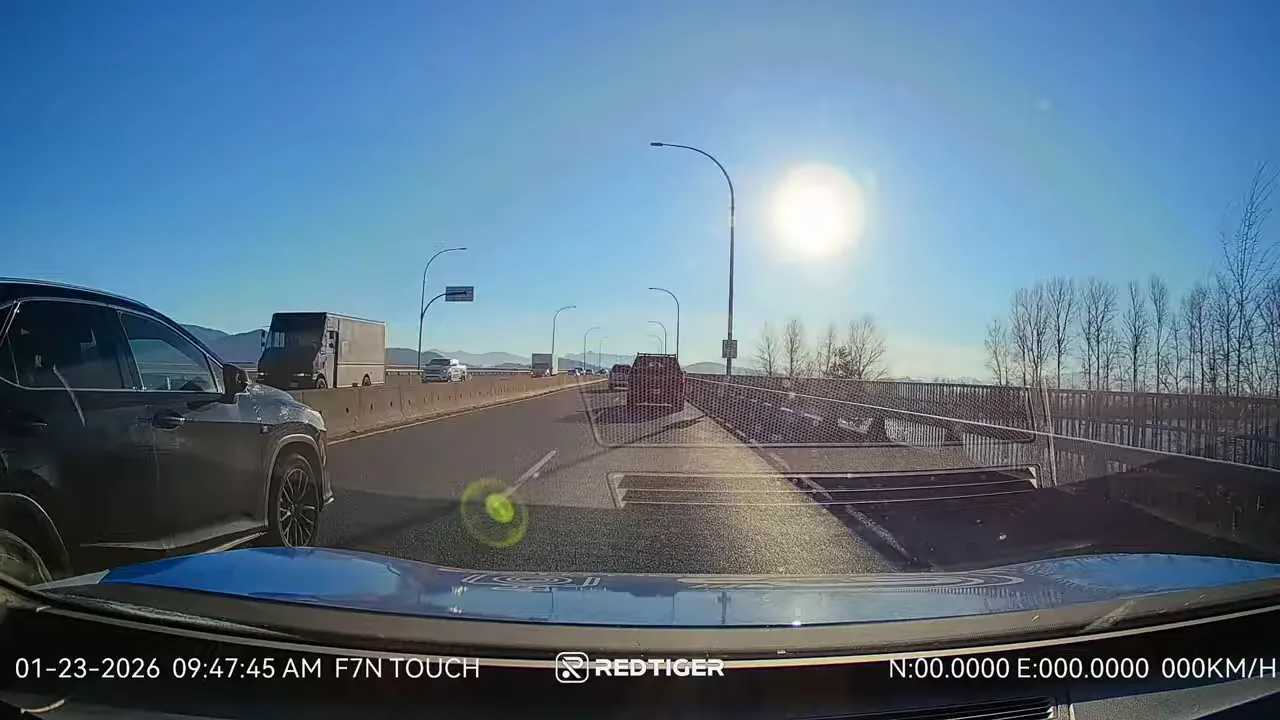 Dash cam footage driving on a highway with bright sun directly ahead