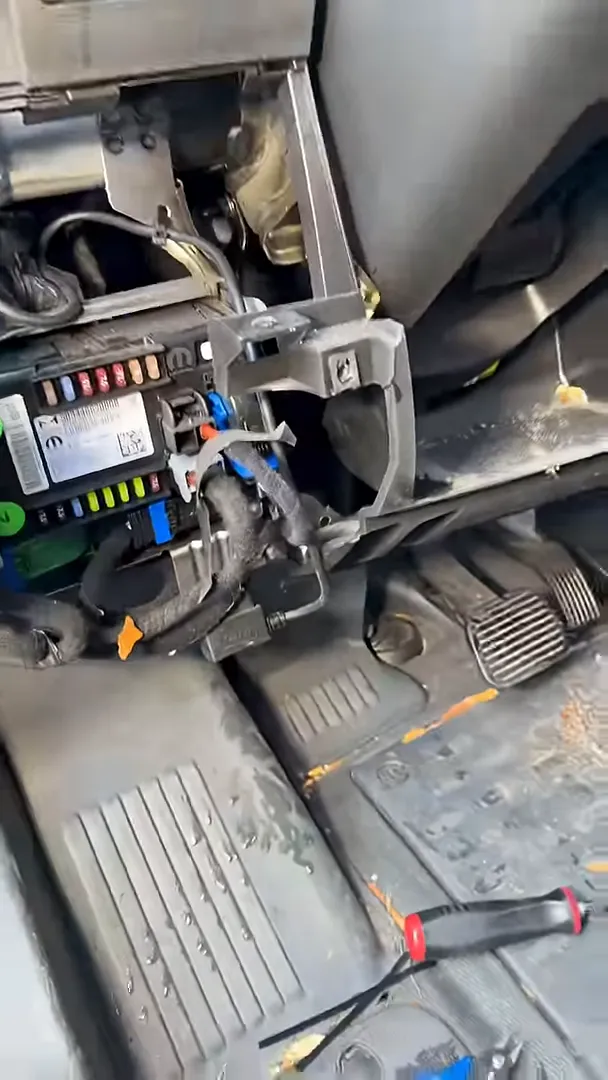 Under-dash view showing fuse module, wrapped wiring routed neatly and access to pedals