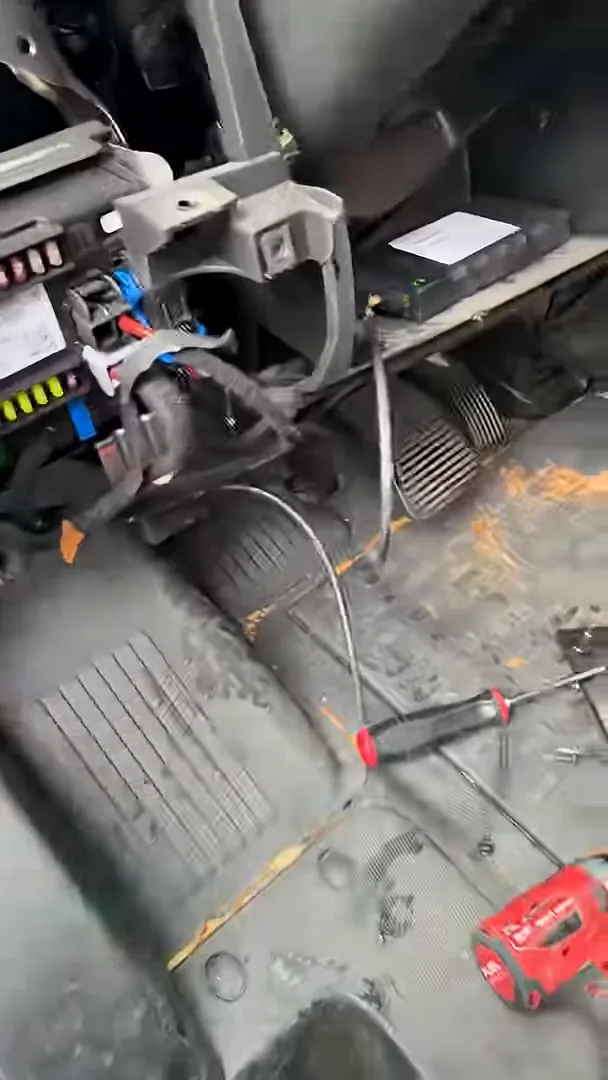 gps module placed on dash shelf with loose cables running across footwell