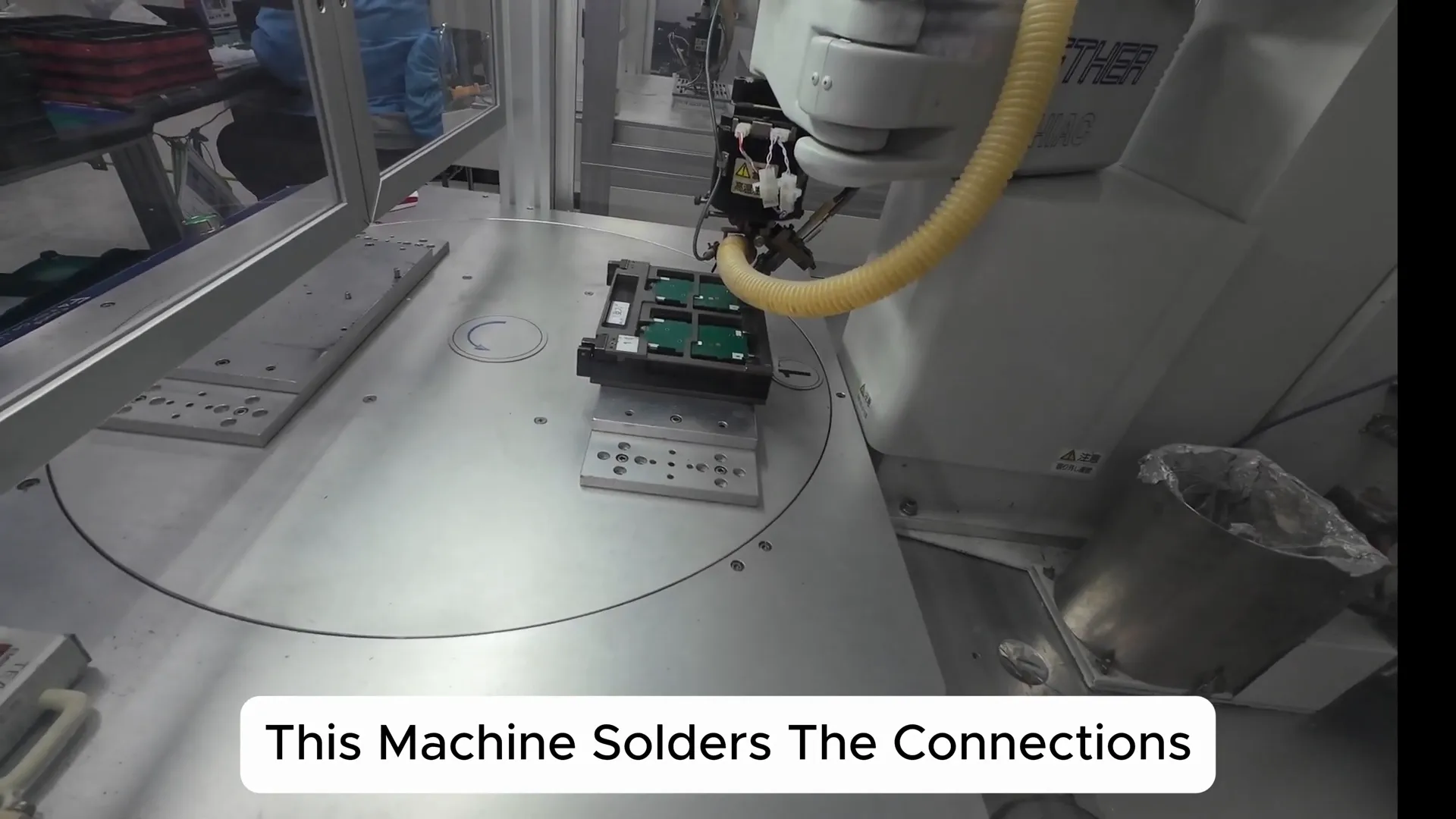 Workers performing manual insertion and soldering