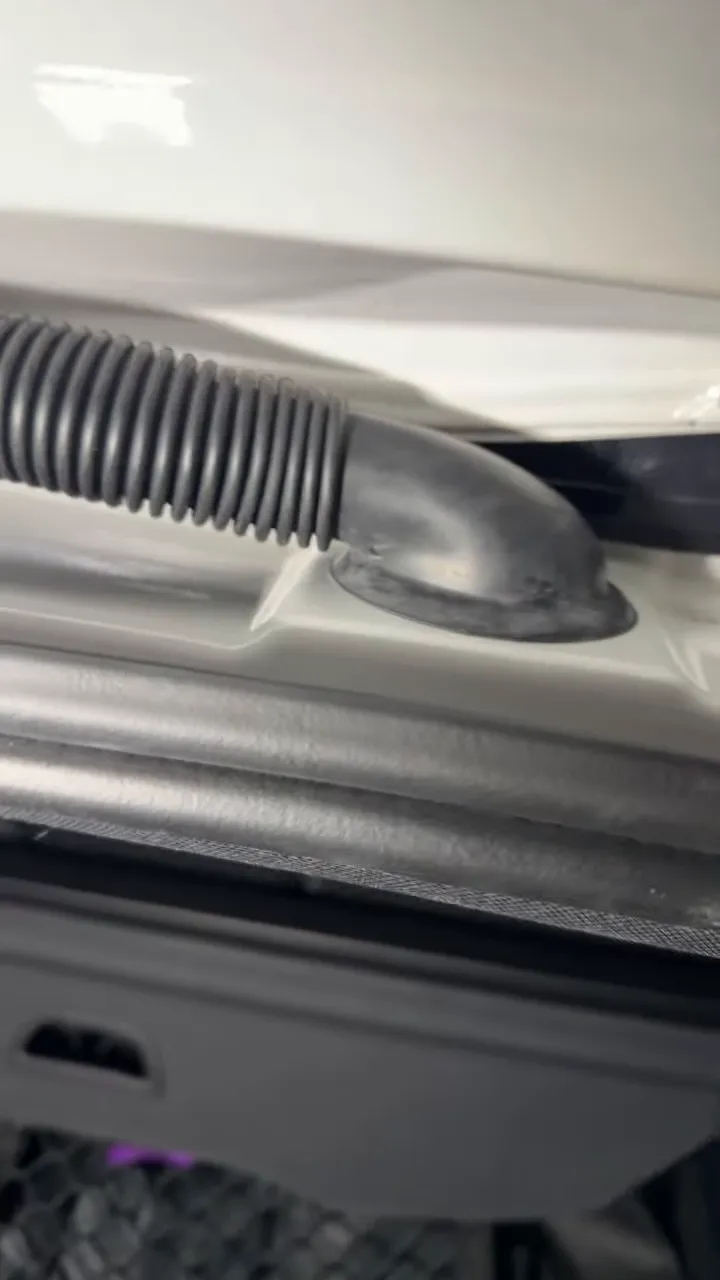 Rubber liftgate wiring boot seated back into the white vehicle body panel