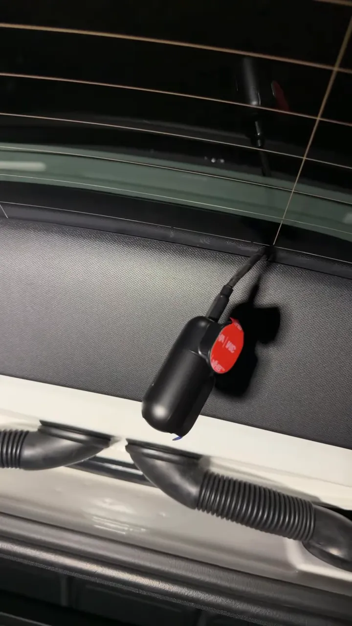 Small black rear dash camera positioned against the Mercedes EQB rear window
