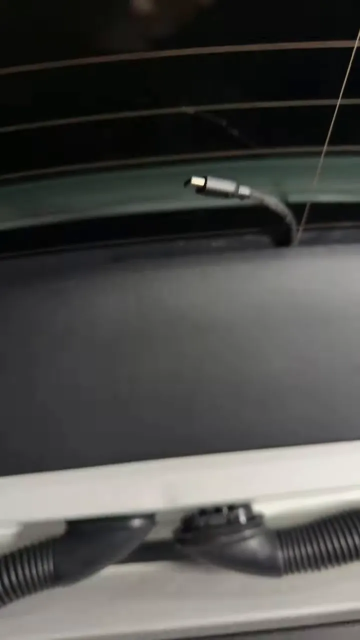 Rear camera cable emerging at the top of the Mercedes EQB rear hatch trim