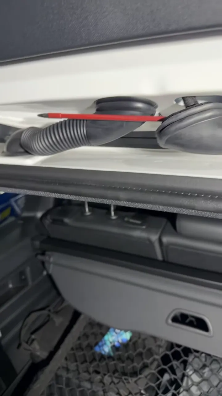 Red wire fish tool routed across the Mercedes EQB liftgate wiring area