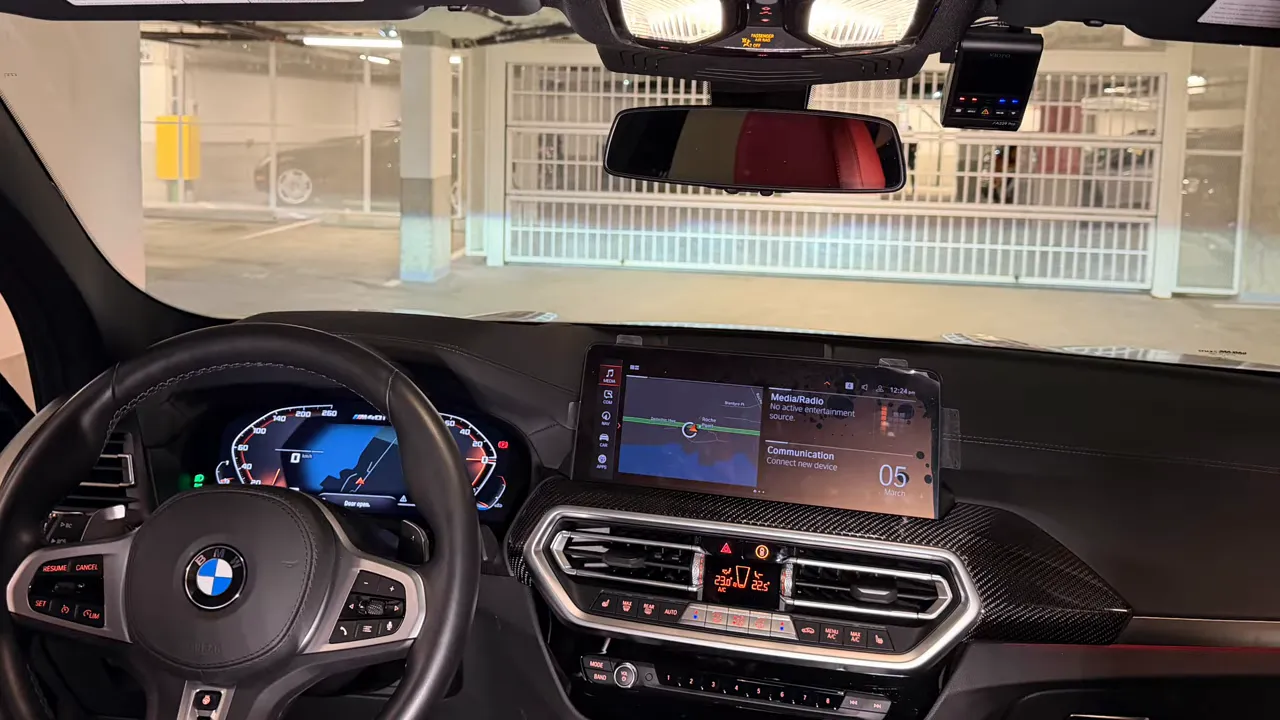 BMW X4 interior showing Viofo dash cam mounted by the rearview mirror and tidy dashboard