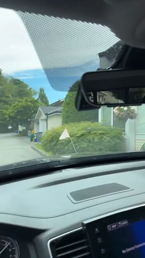Front dash camera mounted behind rearview mirror in Honda Ridgeline
