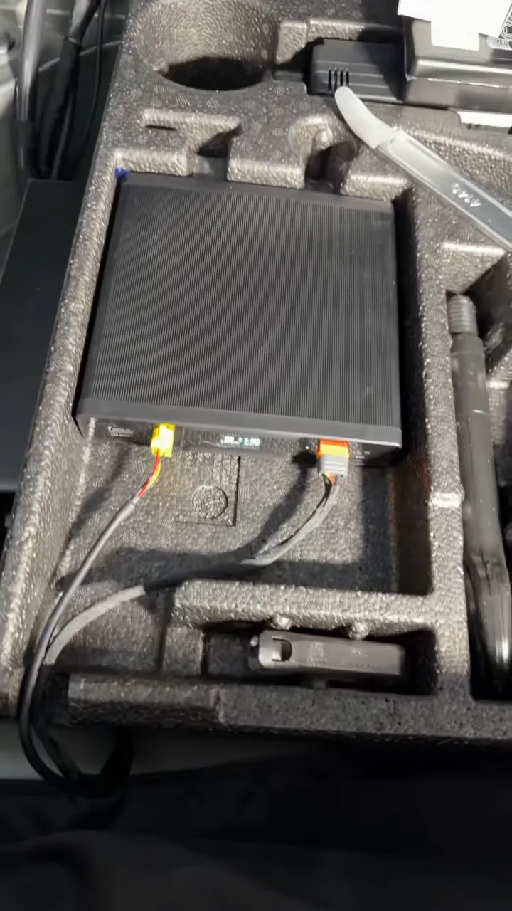 battery pack sitting in rear foam storage tray with connected wires
