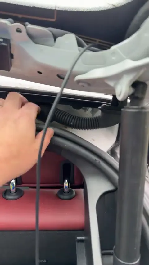 Removing rubber grommet to fish wire through BMW i4 hatch