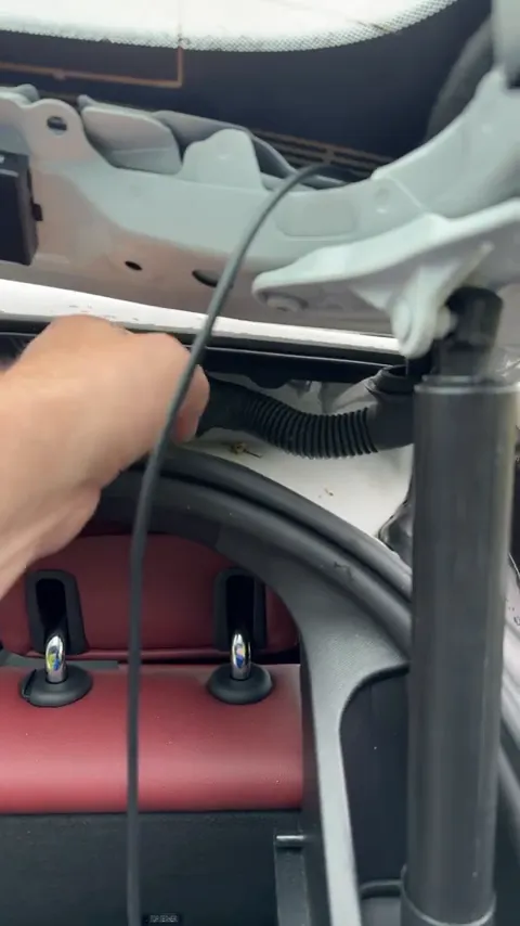 Fish the wire through the rubber grommet of the BMW i4 hatch