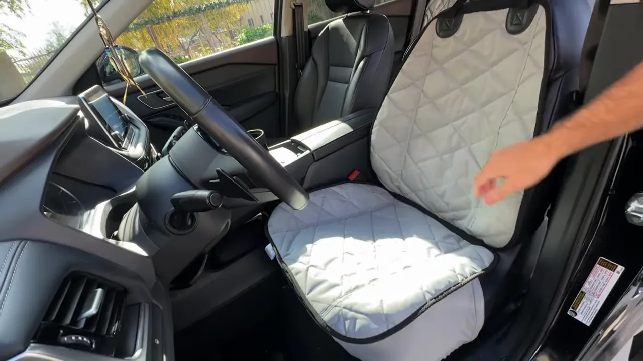 Quilted front bucket seat cover fitted on the Nissan Rogue driver seat