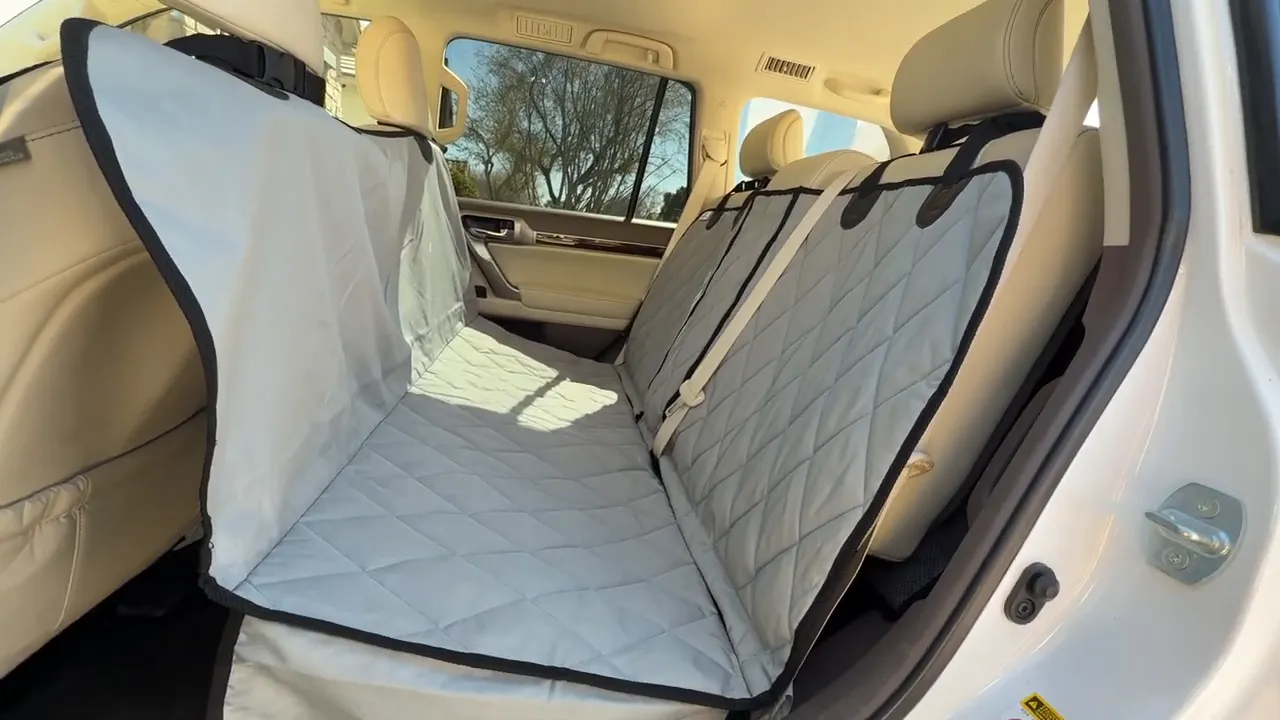 Gray split hammock seat cover installed across the Lexus GX rear bench with a center seat belt visible