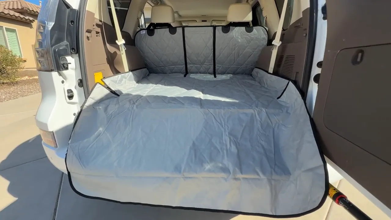 Gray quilted cargo liner covering the Lexus GX cargo area and bumper edge