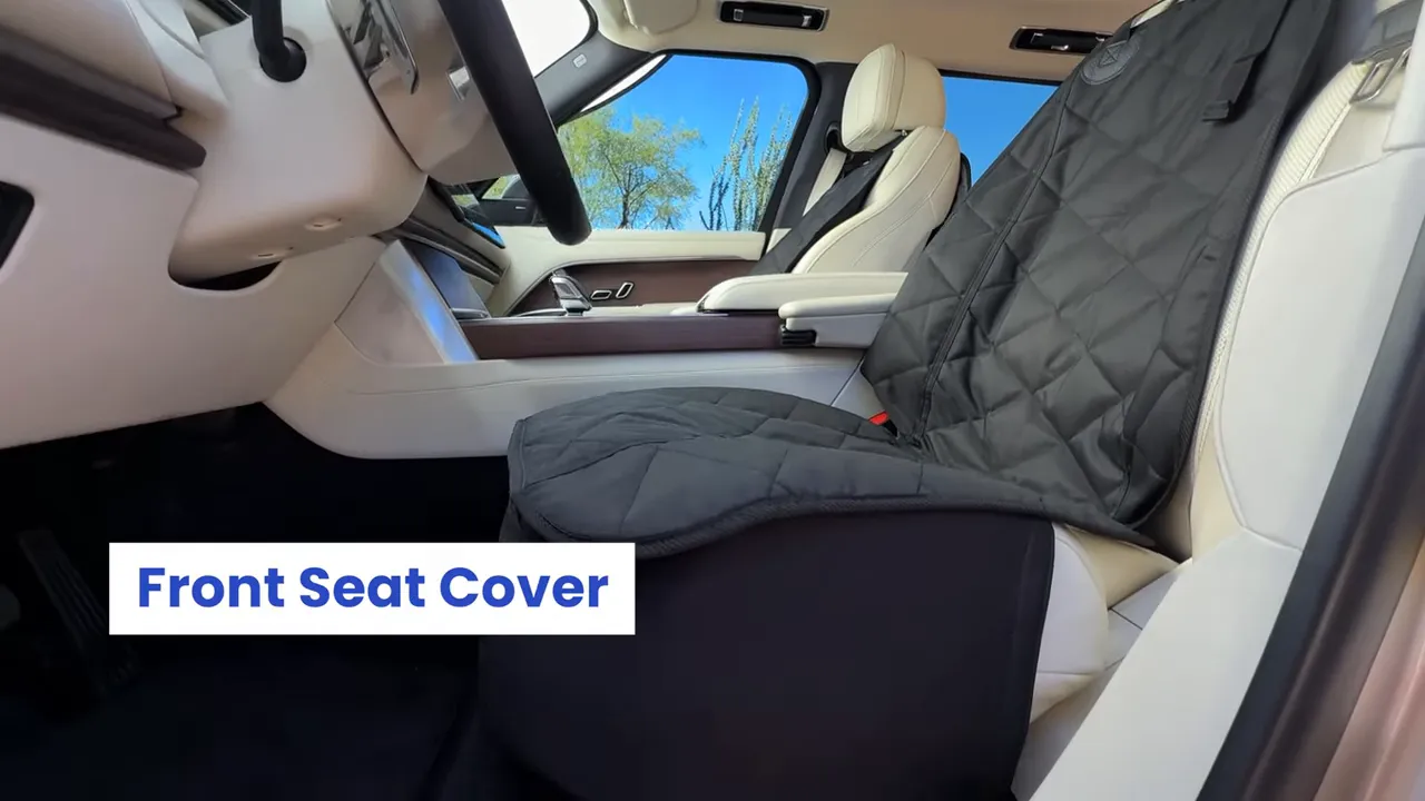 Black quilted front seat cover fitted over a white Range Rover driver seat with side panel visible