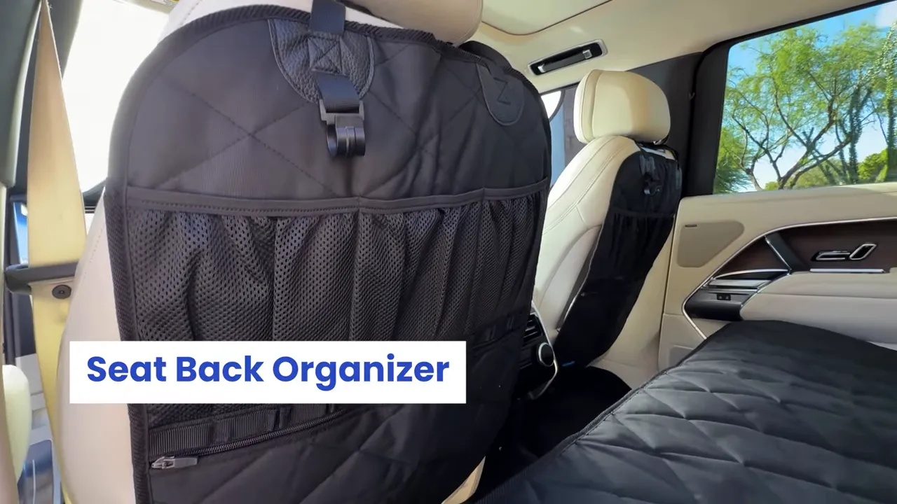 Black quilted seat back organizer with mesh storage pockets attached to the back of a Range Rover front seat